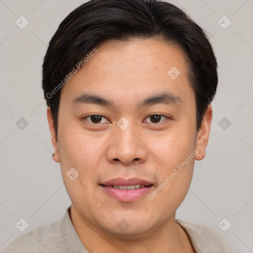 Joyful asian young-adult male with short  brown hair and brown eyes