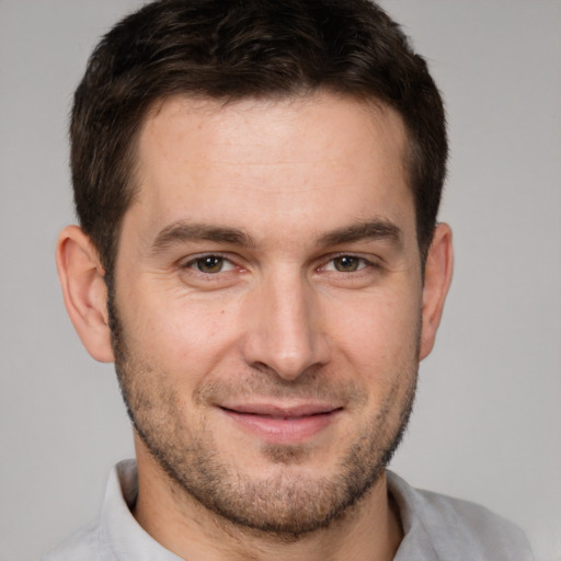 Joyful white young-adult male with short  brown hair and brown eyes