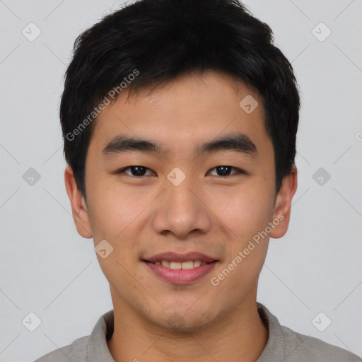 Joyful asian young-adult male with short  black hair and brown eyes