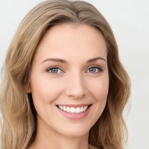 Joyful white young-adult female with long  brown hair and green eyes