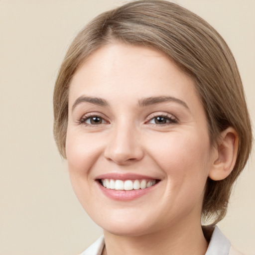 Joyful white young-adult female with medium  brown hair and green eyes