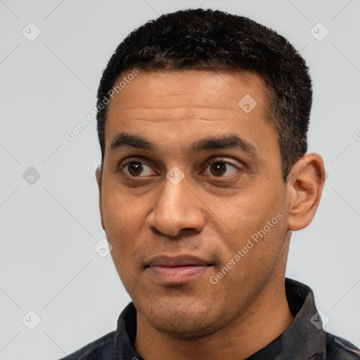 Joyful latino adult male with short  black hair and brown eyes