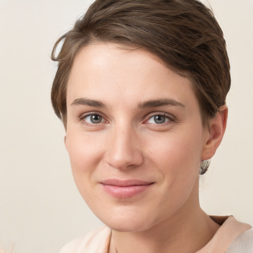 Joyful white young-adult female with short  brown hair and grey eyes