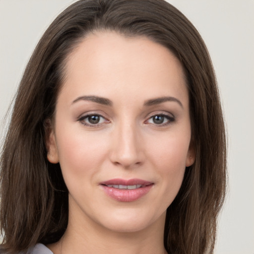 Joyful white young-adult female with long  brown hair and grey eyes