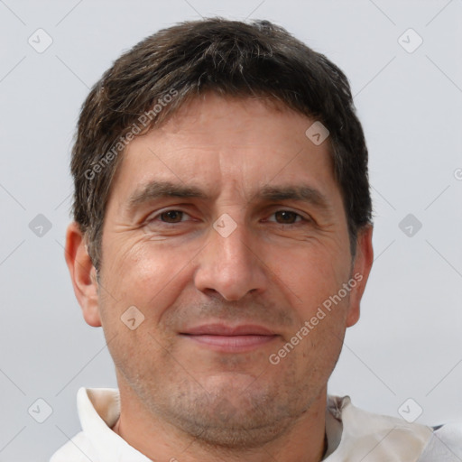 Joyful white adult male with short  brown hair and brown eyes