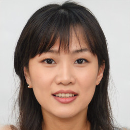 Joyful asian young-adult female with long  brown hair and brown eyes