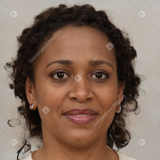 Joyful black adult female with medium  brown hair and brown eyes