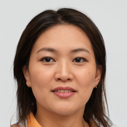 Joyful asian young-adult female with medium  brown hair and brown eyes