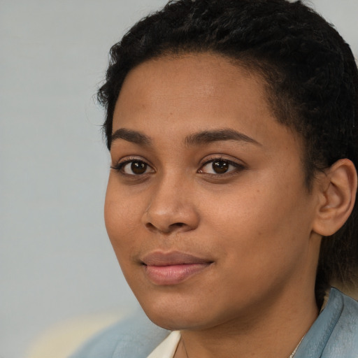 Joyful latino young-adult female with short  black hair and brown eyes