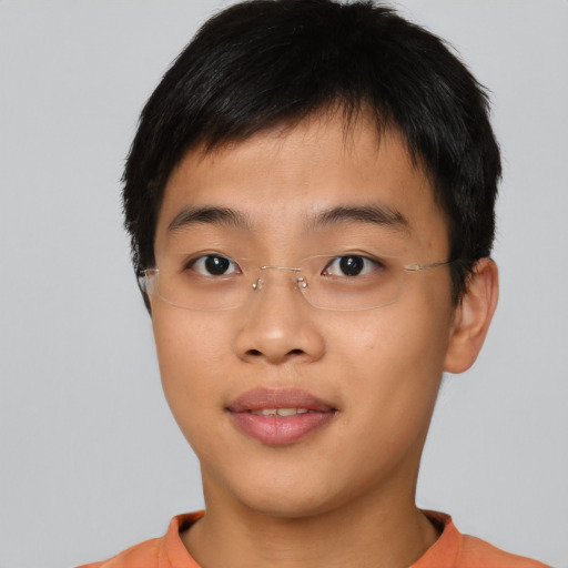 Joyful asian young-adult male with short  brown hair and brown eyes