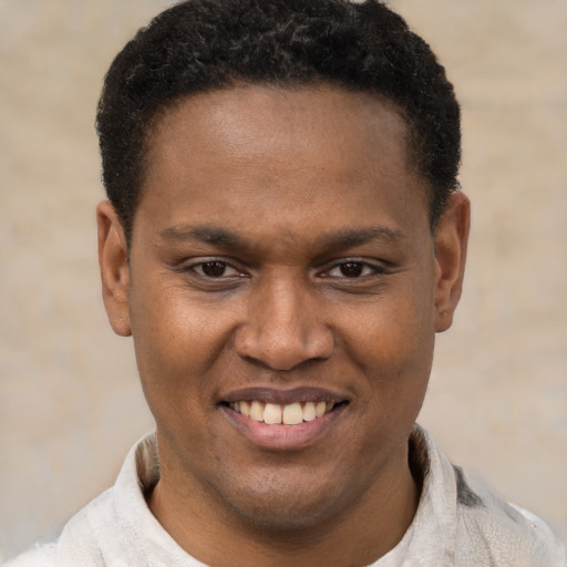 Joyful latino young-adult male with short  brown hair and brown eyes