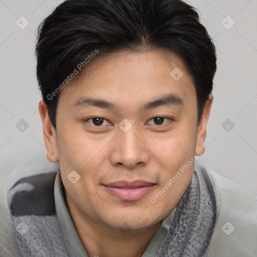 Joyful asian young-adult male with short  brown hair and brown eyes