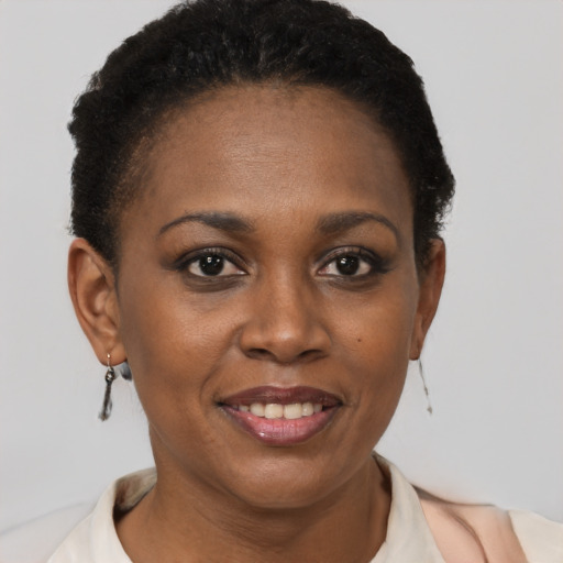 Joyful black young-adult female with short  brown hair and brown eyes