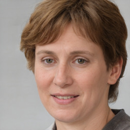 Joyful white adult female with medium  brown hair and grey eyes