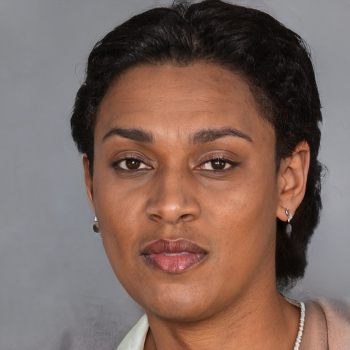 Neutral latino adult female with short  black hair and brown eyes
