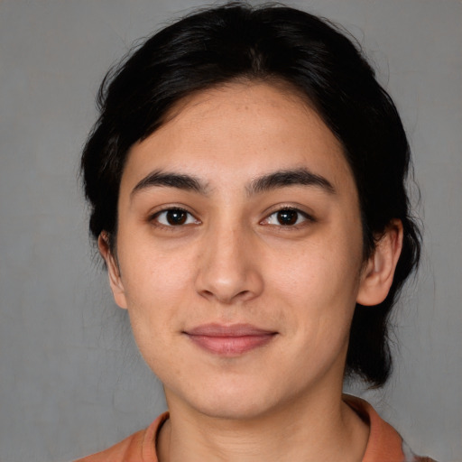 Joyful white young-adult female with medium  black hair and brown eyes