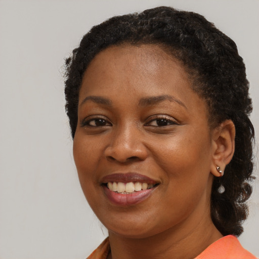 Joyful black young-adult female with medium  brown hair and brown eyes