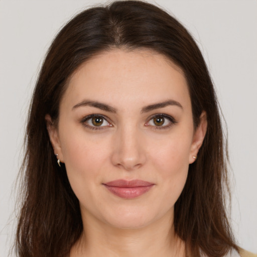 Joyful white young-adult female with long  brown hair and brown eyes