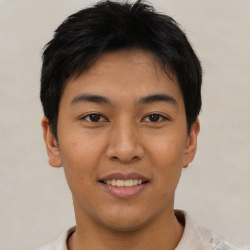 Joyful asian young-adult male with short  brown hair and brown eyes