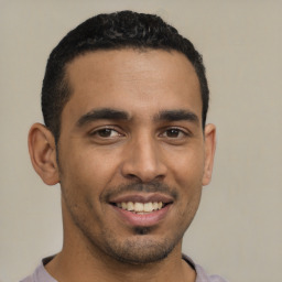 Joyful latino young-adult male with short  brown hair and brown eyes