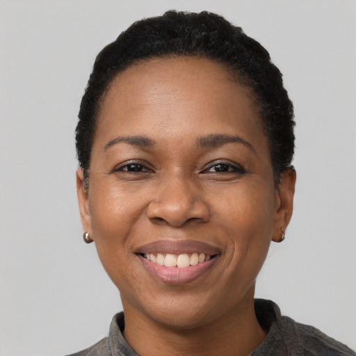 Joyful black adult female with short  brown hair and brown eyes