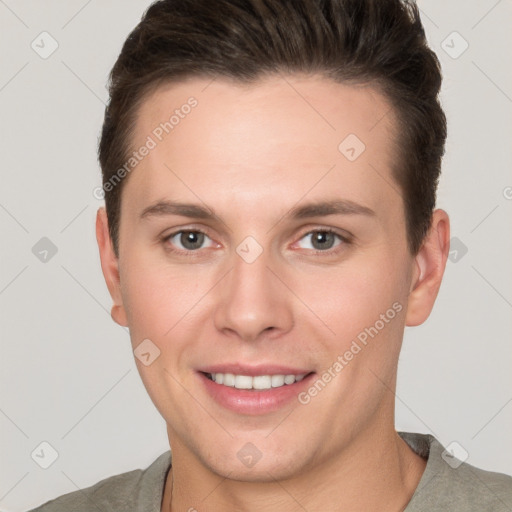 Joyful white young-adult male with short  brown hair and grey eyes