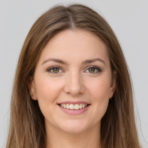 Joyful white young-adult female with long  brown hair and grey eyes