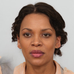 Joyful black adult female with medium  brown hair and brown eyes