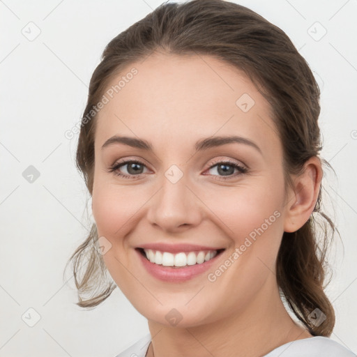 Joyful white young-adult female with medium  brown hair and grey eyes