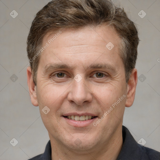 Joyful white adult male with short  brown hair and grey eyes