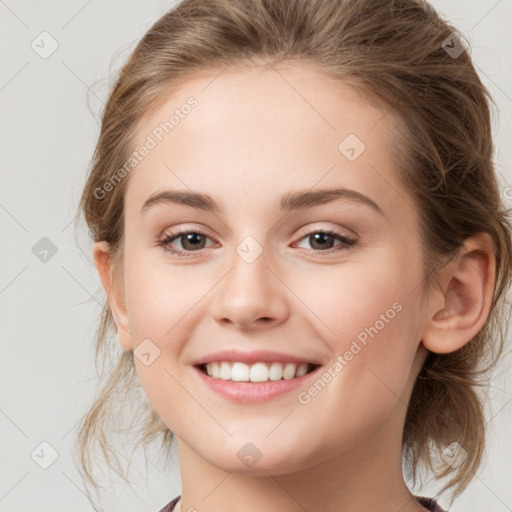 Joyful white young-adult female with medium  brown hair and grey eyes