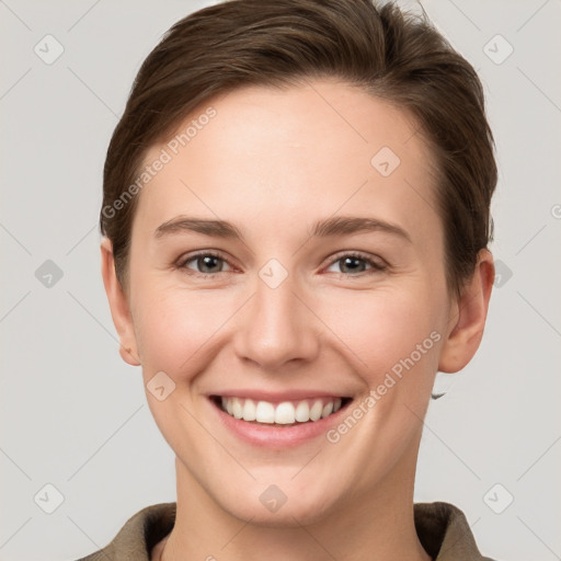 Joyful white young-adult female with short  brown hair and grey eyes