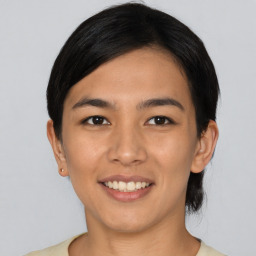 Joyful asian young-adult female with short  black hair and brown eyes