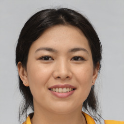 Joyful asian young-adult female with medium  brown hair and brown eyes