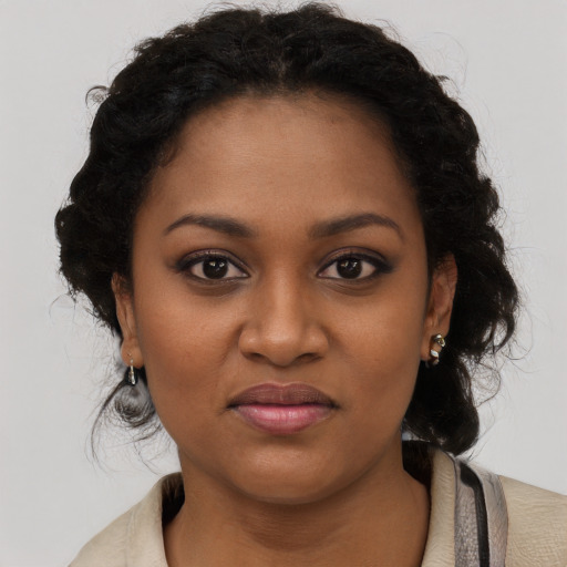 Joyful black young-adult female with medium  brown hair and brown eyes