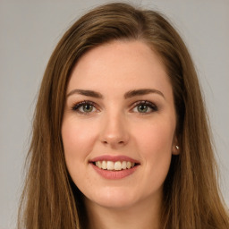 Joyful white young-adult female with long  brown hair and green eyes