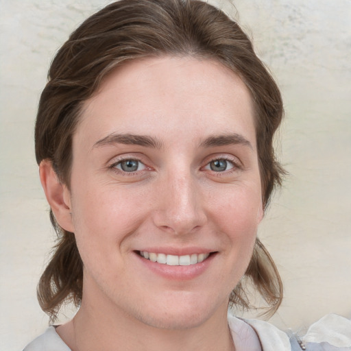 Joyful white young-adult female with medium  brown hair and blue eyes