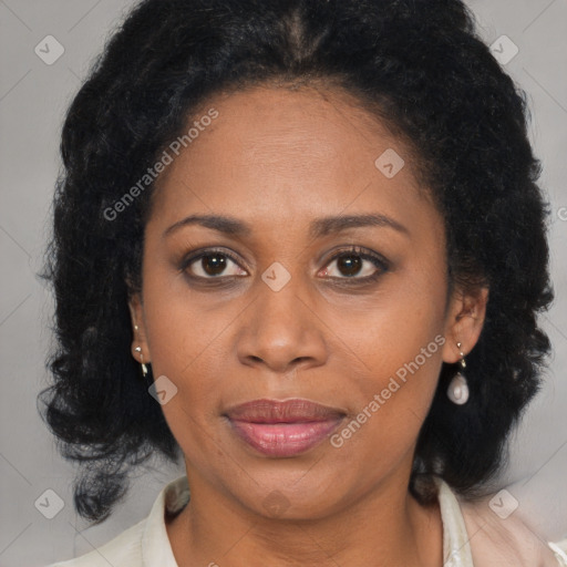 Joyful black adult female with medium  brown hair and brown eyes