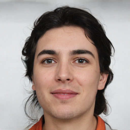 Joyful white young-adult male with medium  brown hair and brown eyes