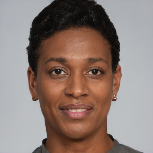 Joyful black young-adult female with short  black hair and brown eyes