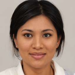 Joyful asian young-adult female with medium  brown hair and brown eyes