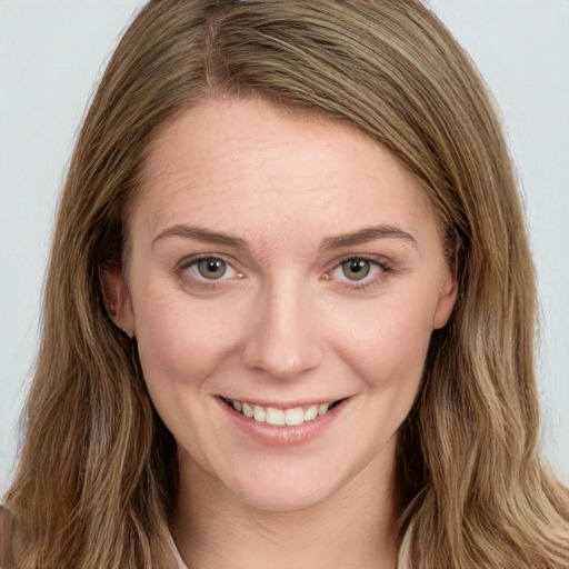 Joyful white young-adult female with long  brown hair and green eyes