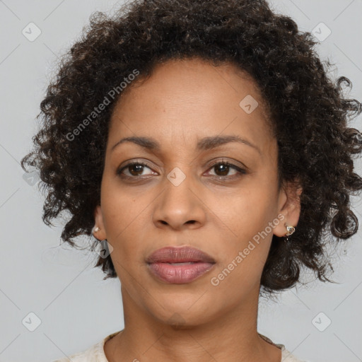 Joyful black adult female with medium  brown hair and brown eyes