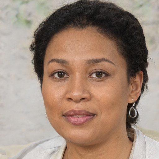 Joyful latino adult female with short  brown hair and brown eyes