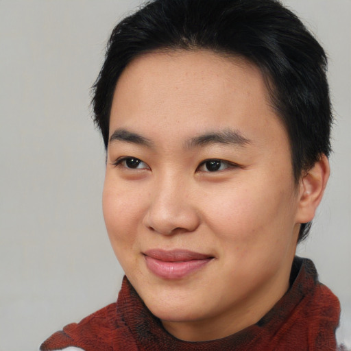 Joyful asian young-adult female with short  brown hair and brown eyes