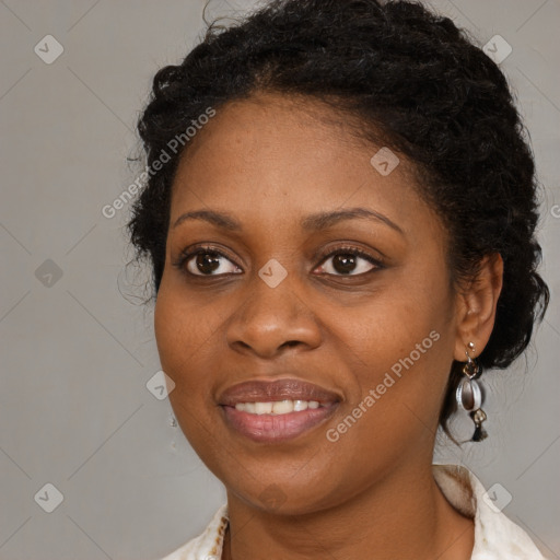 Joyful black young-adult female with long  brown hair and brown eyes