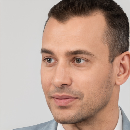 Joyful white adult male with short  brown hair and brown eyes