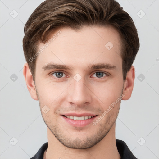 Joyful white young-adult male with short  brown hair and grey eyes