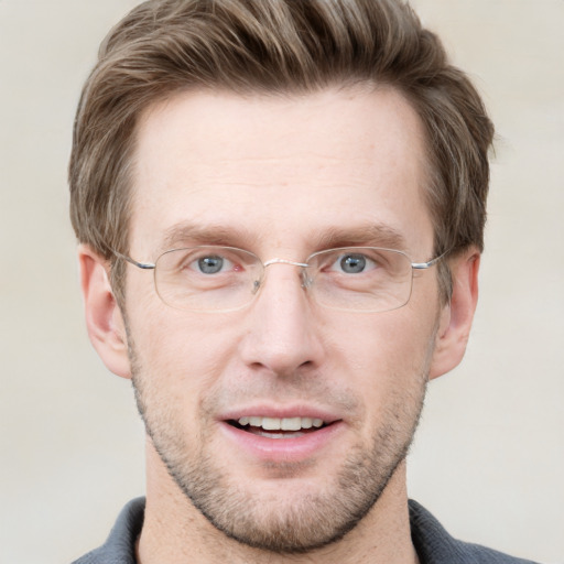 Joyful white adult male with short  brown hair and grey eyes