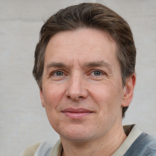 Joyful white adult male with short  brown hair and grey eyes